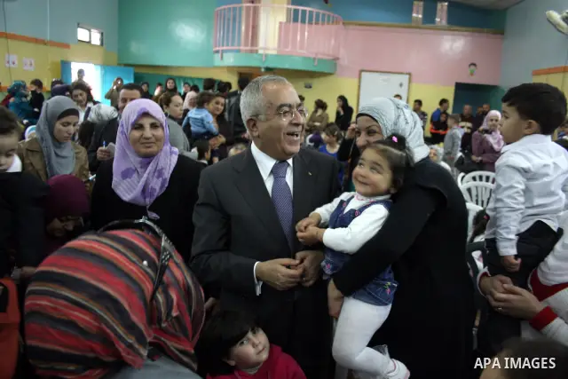 Palestinian Prime Minister Salam Fayyad participates in a celebration at "the happiness of Childhood Center" on the occasion of Mother Day in the West Bank city of Ramallah on March 21, 2011. Photo by Issam Rimawi