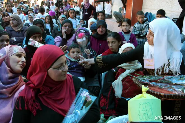 Palestinian women attend a celebration at Al-Walajah school on the occasion of Mother Day in Walajah village near the West Bank city of Bethlehem on March 21, 2011. Photo by Issam Rimawi