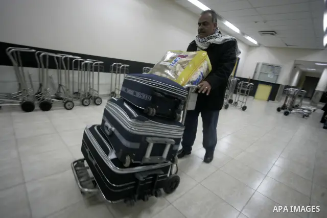 Palestinians arrive at their side of the Rafah border crossing with Egypt in the southern Gaza Strip on March 21, 2011 after some 44 Palestinians struggled to flee the violent rebellion against Libyan leader Moamer Kadha...
