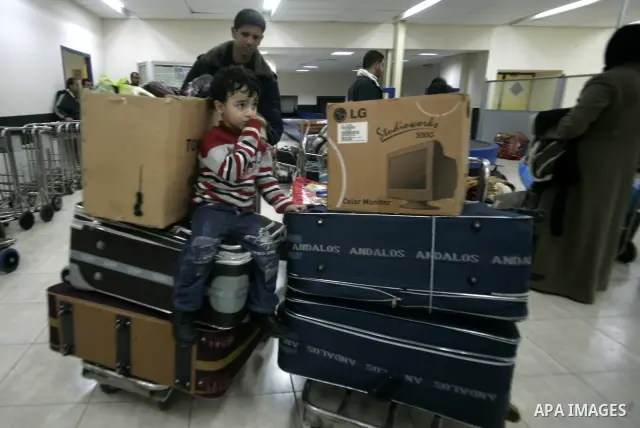 Palestinians arrive at their side of the Rafah border crossing with Egypt in the southern Gaza Strip on March 21, 2011 after some 44 Palestinians struggled to flee the violent rebellion against Libyan leader Moamer Kadha...