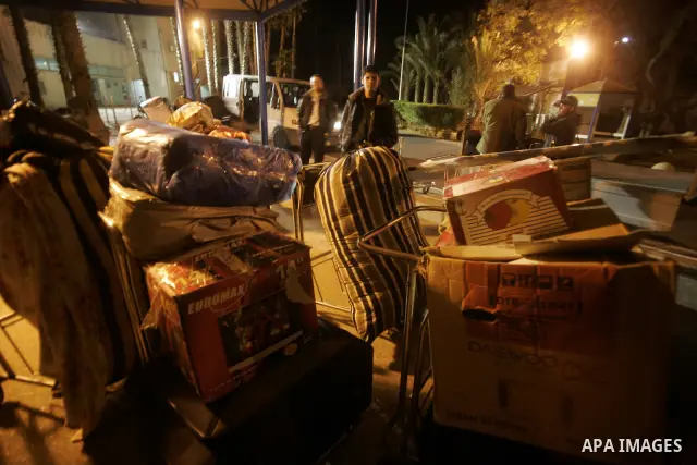 Palestinians arrive at their side of the Rafah border crossing with Egypt in the southern Gaza Strip on March 21, 2011 after some 44 Palestinians struggled to flee the violent rebellion against Libyan leader Moamer Kadha...