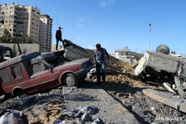 Palestinians inspect a destroyed Hamas compound after an Israeli strike overnight in Gaza City on March 22, 2011 as Israel staged air raids in Gaza overnight, wounding 17 people, Palestinian medics said, after militants...