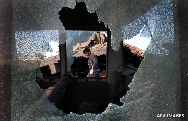Palestinian inspects a destroyed Hamas compound after an Israeli strike overnight in Gaza City on March 22, 2011 as Israel staged air raids in Gaza overnight, wounding 17 people, Palestinian medics said, after militants...