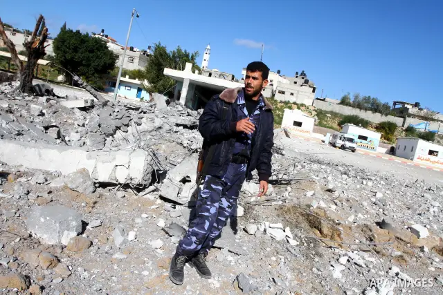 Palestinian Hamas security stand amidst the rubble of a destroyed Hamas compound after its strike by an Israeli war plane overnight in Beit Lahiya town in the northern Gaza Strip on, 22 March 2011. on Feb. 27,2011. Photo...