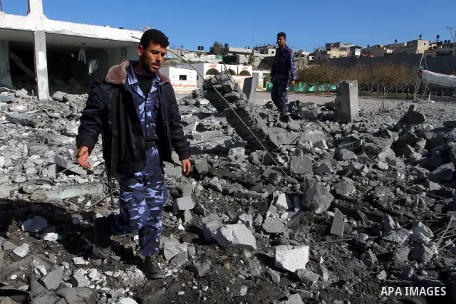 Palestinian Hamas security stand amidst the rubble of a destroyed Hamas compound after its strike by an Israeli war plane overnight in Beit Lahiya town in the northern Gaza Strip on, 22 March 2011. on Feb. 27,2011. Photo...