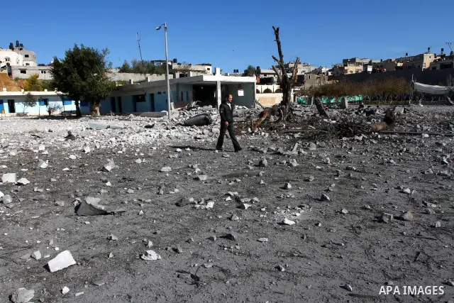 Palestinian Hamas security stand amidst the rubble of a destroyed Hamas compound after its strike by an Israeli war plane overnight in Beit Lahiya town in the northern Gaza Strip on, 22 March 2011. on Feb. 27,2011. Photo...