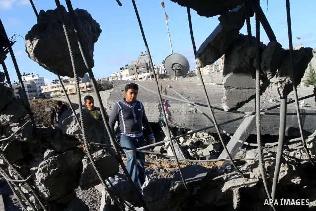 Palestinian inspects a destroyed Hamas compound after an Israeli strike overnight in Gaza City on March 22, 2011 as Israel staged air raids in Gaza overnight, wounding 17 people, Palestinian medics said, after militants...