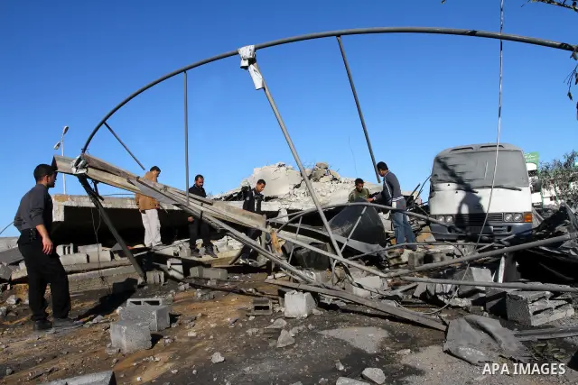Palestinian inspects a destroyed Hamas compound after an Israeli strike overnight in Gaza City on March 22, 2011 as Israel staged air raids in Gaza overnight, wounding 17 people, Palestinian medics said, after militants...
