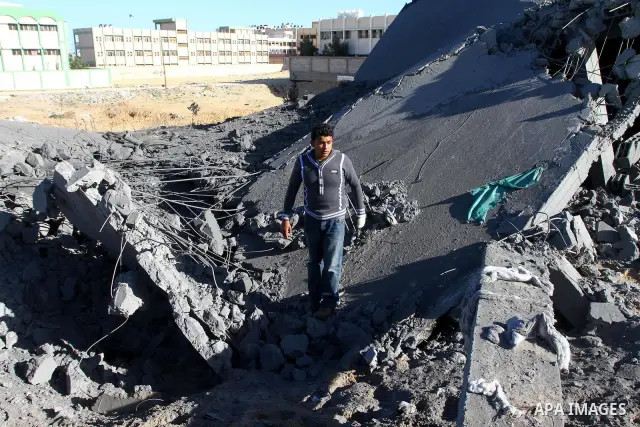 Palestinian inspects a destroyed Hamas compound after an Israeli strike overnight in Gaza City on March 22, 2011 as Israel staged air raids in Gaza overnight, wounding 17 people, Palestinian medics said, after militants...