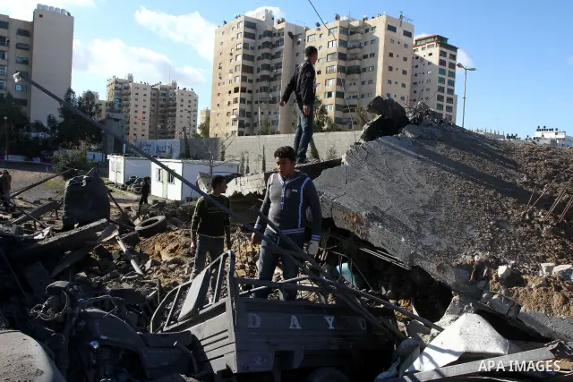 Palestinian inspects a destroyed Hamas compound after an Israeli strike overnight in Gaza City on March 22, 2011 as Israel staged air raids in Gaza overnight, wounding 17 people, Palestinian medics said, after militants...