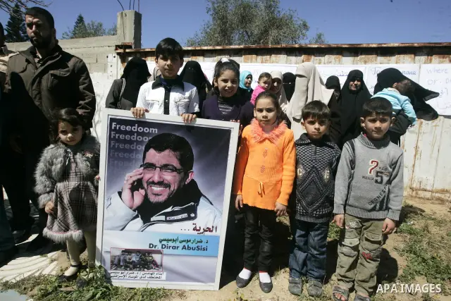 Co-workers and family members of palestinian kidnapped engineer Derar Abu Sissi hold his photos during protest calling for his release in Gaza March 22,2011. Derar Abu sissi was kidnapped by the mossad men in Ukrania on...
