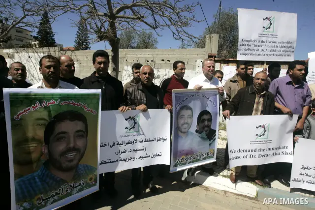 Co-workers and family members of palestinian kidnapped engineer Derar Abu Sissi hold his photos during protest calling for his release in Gaza March 22,2011. Derar Abu sissi was kidnapped by the mossad men in Ukrania on...
