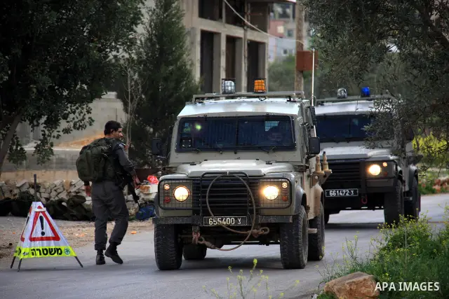 Israeli troops operate during a military operation searching for suspects in the West Bank village of Awarta near Nablus,the army Imposed a curfew in the village following an attack in a nearby Jewish settlement that kil...