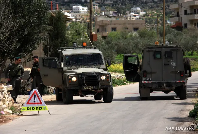 Israeli troops operate during a military operation searching for suspects in the West Bank village of Awarta near Nablus,the army Imposed a curfew in the village following an attack in a nearby Jewish settlement that kil...