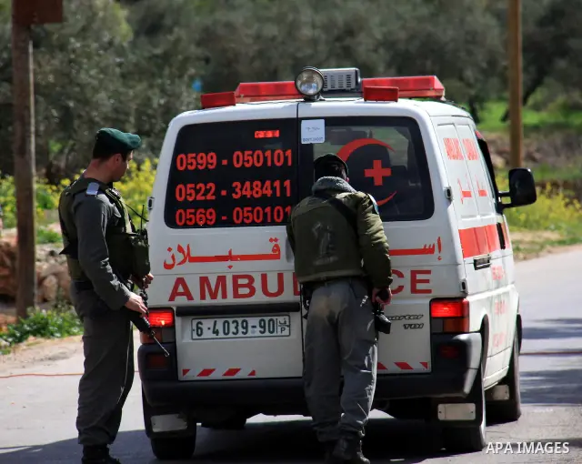 Israeli soldiers check a Palestinian ambulance ,during a military operation searching for suspects in the West Bank village of Awarta near Nablus,the army Imposed a curfew in the village following an attack in a nearby J...