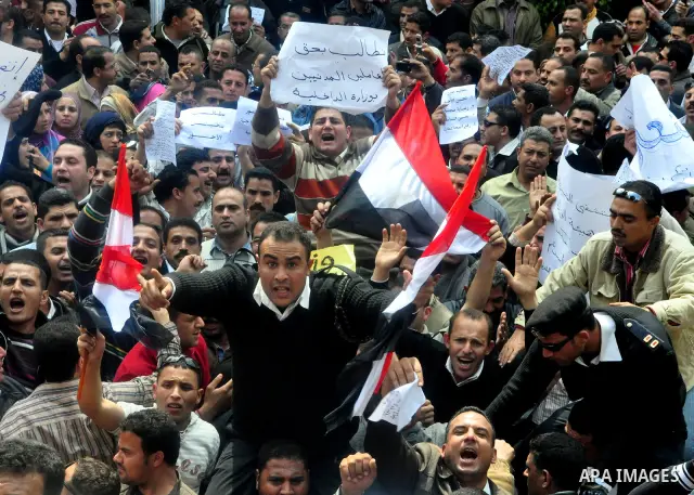Egyptian police protest in front of the Interior Ministry calling for a raise in their wages in Cairo, Egypt, Tuesday, March 22, 2011. The Arabic on building reads:" Interior Ministry.". Photo by Ahmed Asad