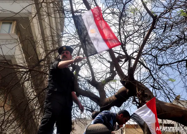 Egyptian police protest in front of the Interior Ministry calling for a raise in their wages in Cairo, Egypt, Tuesday, March 22, 2011. The Arabic on building reads:" Interior Ministry.". Photo by Ahmed Asad