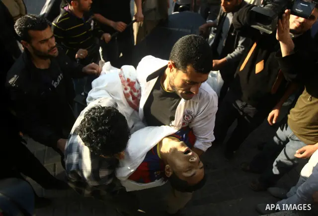 Palestinians carry the body of a Palestinian killed in an Israeli shells, after was brought to the morgue of Shifa hospital in Gaza City, Tuesday, March 22, 2011. Israeli tank fire struck a house in the Gaza Strip on Tue...