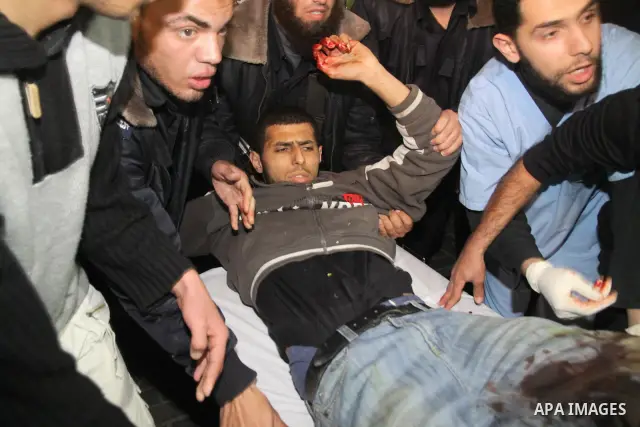 Palestinians carry a wounded man into Al-Shifa hospital in Gaza City, after an Israeli air strike March 22, 2011. The air strike killed four Palestinians militants in Gaza on Tuesday, Hamas officials said after four Pale...