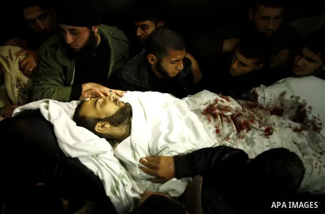 A Palestinian militant killed in an Israeli air strike is deplaced at al-Shifa hospital in Gaza City on March 22, 2011. Three members of the Al Quds Brigades, the armed wing of the radical Islamic Jihad, were killed and...