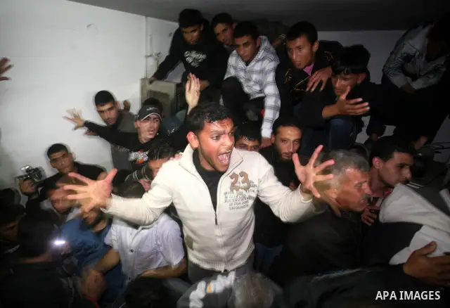 A Palestinian militant killed in an Israeli air strike is deplaced at al-Shifa hospital in Gaza City on March 22, 2011. Three members of the Al Quds Brigades, the armed wing of the radical Islamic Jihad, were killed and...