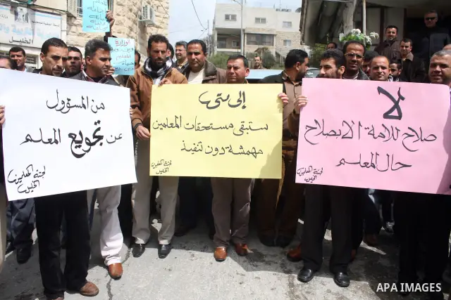 Palestinian teachers take part in a demonstration outside the office of the Directorate of Education in the West Bank city of Hebron on March 23 ,2011. Photo by Najeh Hashlamoun.