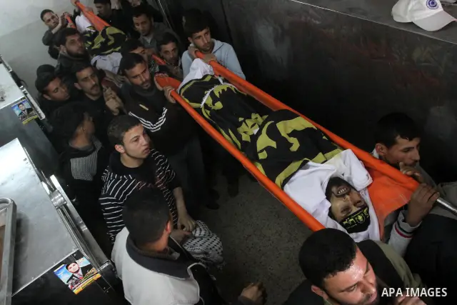 Palestinian mourners carry the bodies of Palestinians during a funeral at a hospital in Gaza City, Gaza Strip, 23 March, 2011 a day after eight Gazans were killed, among them two minors and four militants, as tensions so...