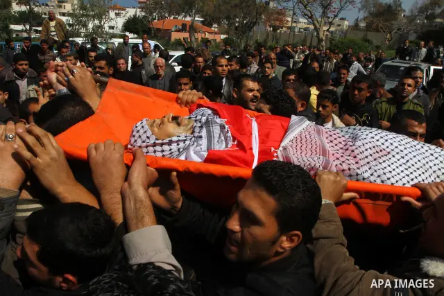 Palestinian mourners carry the bodies of Palestinians during a funeral in Al-Shjaea eastern Gaza City, Gaza Strip, 23 March, 2011 a day after eight Gazans were killed, among them two minors and four militants, as tension...
