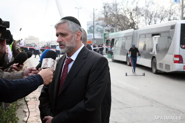 An Israeli official speaks to media at the scene of a bomb attack at a bus station in Jerusalem blowing up next to the bus and near a kiosk, called the 'Explosive Kiosk', on 23 March 2011. Over 30 people were injured by...