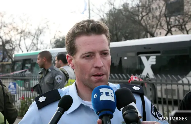 An Israeli official speaks to media at the scene of a bomb attack at a bus station in Jerusalem blowing up next to the bus and near a kiosk, called the 'Explosive Kiosk', on 23 March 2011. Over 30 people were injured by...
