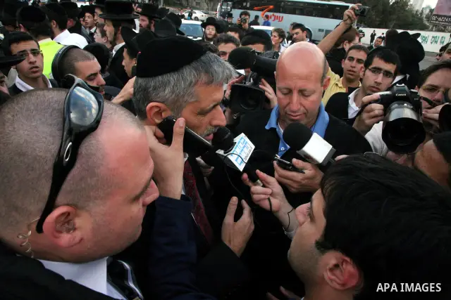 An Israeli official speaks to media at the scene of a bomb attack at a bus station in Jerusalem blowing up next to the bus and near a kiosk, called the 'Explosive Kiosk', on 23 March 2011. Over 30 people were injured by...