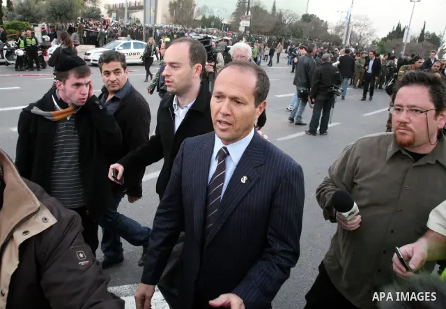 An Israeli official speaks to media at the scene of a bomb attack at a bus station in Jerusalem blowing up next to the bus and near a kiosk, called the 'Explosive Kiosk', on 23 March 2011. Over 30 people were injured by...
