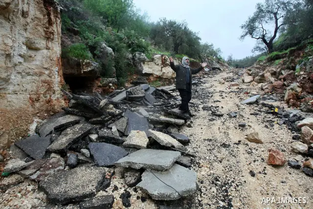 Palestinians inspect the damage road that was partially dug-up and destroyed for the second time by the Israeli army in Qarawat Bani Hassan near the West Bank city of Nablus on March 24, 2011. Photo by Wagdi Eshtayah