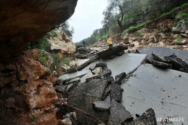 Palestinians inspect the damage road that was partially dug-up and destroyed for the second time by the Israeli army in Qarawat Bani Hassan near the West Bank city of Nablus on March 24, 2011. Photo by Wagdi Eshtayah