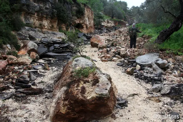 Palestinians inspect the damage road that was partially dug-up and destroyed for the second time by the Israeli army in Qarawat Bani Hassan near the West Bank city of Nablus on March 24, 2011. Photo by Wagdi Eshtayah