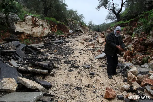 Palestinians inspect the damage road that was partially dug-up and destroyed for the second time by the Israeli army in Qarawat Bani Hassan near the West Bank city of Nablus on March 24, 2011. Photo by Wagdi Eshtayah