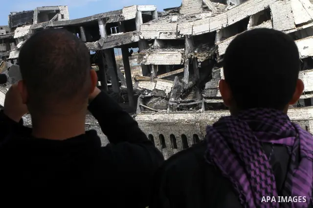 Palestinians observe the destroyed security office in Gaza City, on March 25, 2011, as Israeli aircraft attacked four targets in the Gaza Strip during the night, lightly wounding three people, in response to Palestinian...
