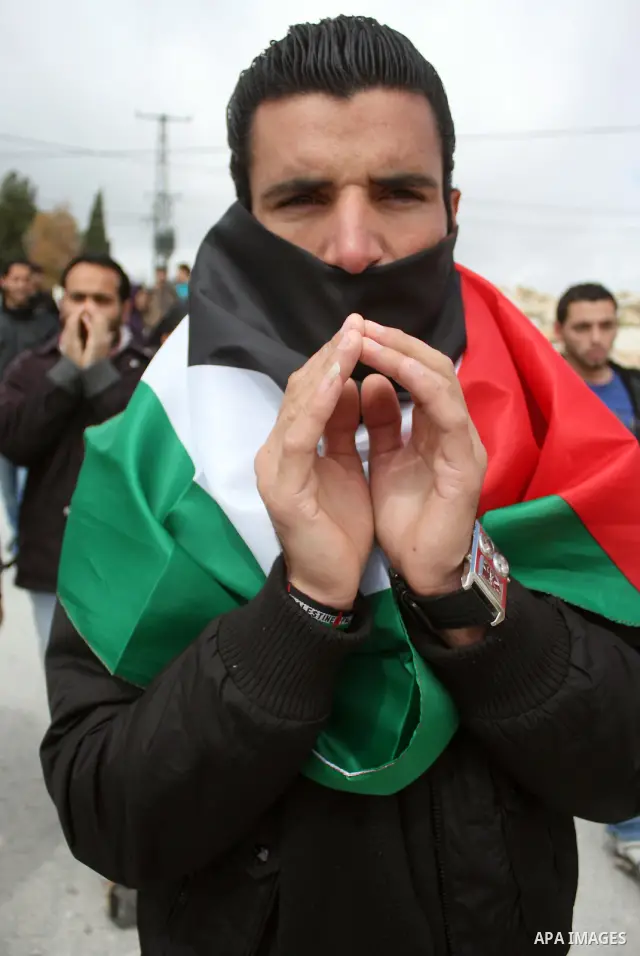 Protesters argue with an Israeli soldier during a demonstration against Israel's controversial separation barrier in the West Bank village of Maasarah, near the biblical town of Bethlehem on March 25, 2011.Israel says th...