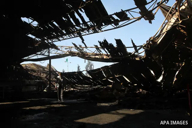 Palestinians observe the damage in a soft drinks factory after an explosion earlier on March 26, 2011 in the Zeitun neighbourhood of Gaza city. Despite Israel military said none of its forces were operating in the area,...