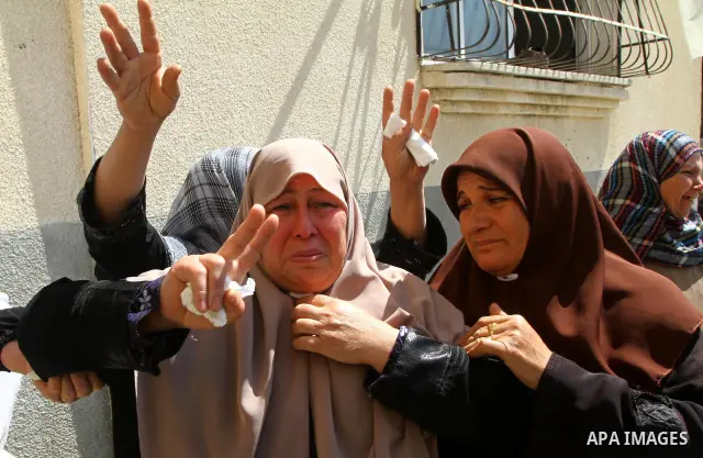 Relatives of Saber Assalya, an Islamic Jihad militant, mourn during his funeral in Jabalya refugee camp, northern Gaza Strip, Sunday, March 27, 2011. Israeli aircraft struck a Palestinian rocket squad in the Gaza Strip o...