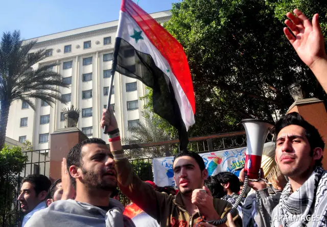Syrians living in Egypt demonstrate against the recent actions of the Syrian government and in support of protesters, outside the Arab League headquarters in Cairo, Egypt Sunday, March 27, 2011. Syrian army units deploye...