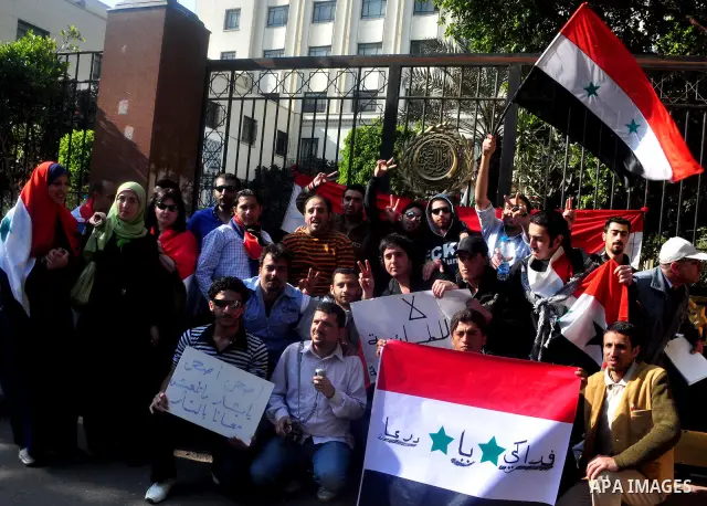 Syrians living in Egypt demonstrate against the recent actions of the Syrian government and in support of protesters, outside the Arab League headquarters in Cairo, Egypt Sunday, March 27, 2011. Syrian army units deploye...