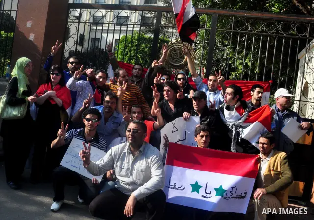 Syrians living in Egypt demonstrate against the recent actions of the Syrian government and in support of protesters, outside the Arab League headquarters in Cairo, Egypt Sunday, March 27, 2011. Syrian army units deploye...