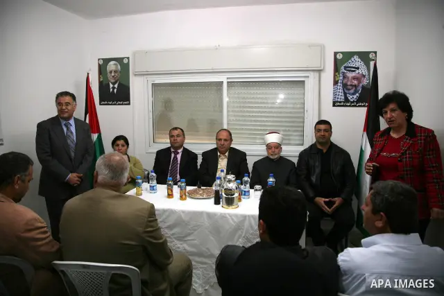 Palestinians attend the opening of the headquarters of the National Alliance for the families of the martyrs in Al-Ram in the West Bank March 27,2011. Sliman Khader
