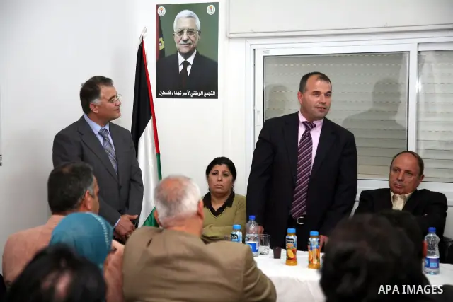 Palestinians attend the opening of the headquarters of the National Alliance for the families of the martyrs in Al-Ram in the West Bank March 27,2011. Sliman Khader