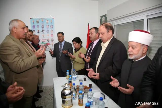 Palestinians attend the opening of the headquarters of the National Alliance for the families of the martyrs in Al-Ram in the West Bank March 27,2011. Sliman Khader