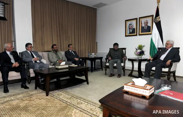 Palestinian President Mahmoud Abbas (Abu Mazen) meets with the writer Mahmoud Choucair the winner of Mahmoud Darwish Award, and the writer Ali Khalil the winner of Personality of the Year in west bank city of Ramallah Ma...