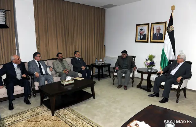 Palestinian President Mahmoud Abbas (Abu Mazen) meets with the writer Mahmoud Choucair the winner of Mahmoud Darwish Award, and the writer Ali Khalil the winner of Personality of the Year in west bank city of Ramallah Ma...
