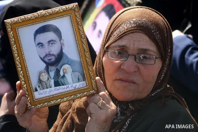 Palestinians women hold pictures of their prisoned relatives in Israeli jails as they gather in a weekly activity calling for their liberty at the Red Cross headquarters in Gaza City on Marsh 28, 2011. About 7000 prisone...