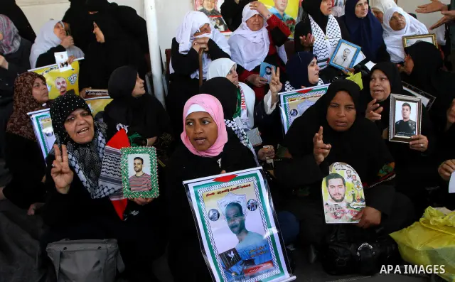 Palestinians women hold pictures of their prisoned relatives in Israeli jails as they gather in a weekly activity calling for their liberty at the Red Cross headquarters in Gaza City on Marsh 28, 2011. About 7000 prisone...